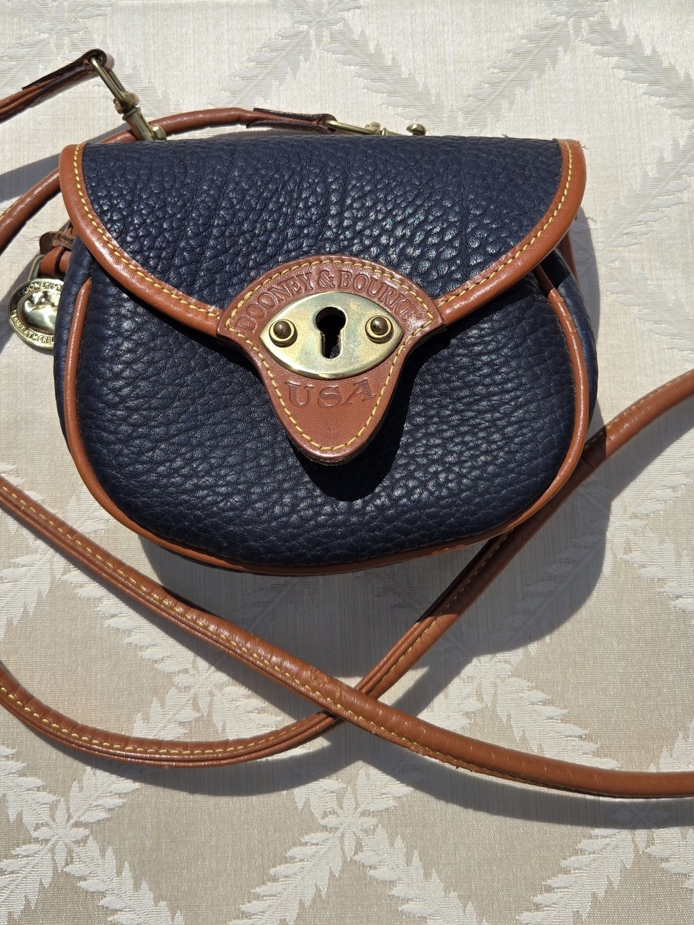 Dooney & Bourke Navy Pebble Leather Crossbody with Brown Trim and Brass Hardware